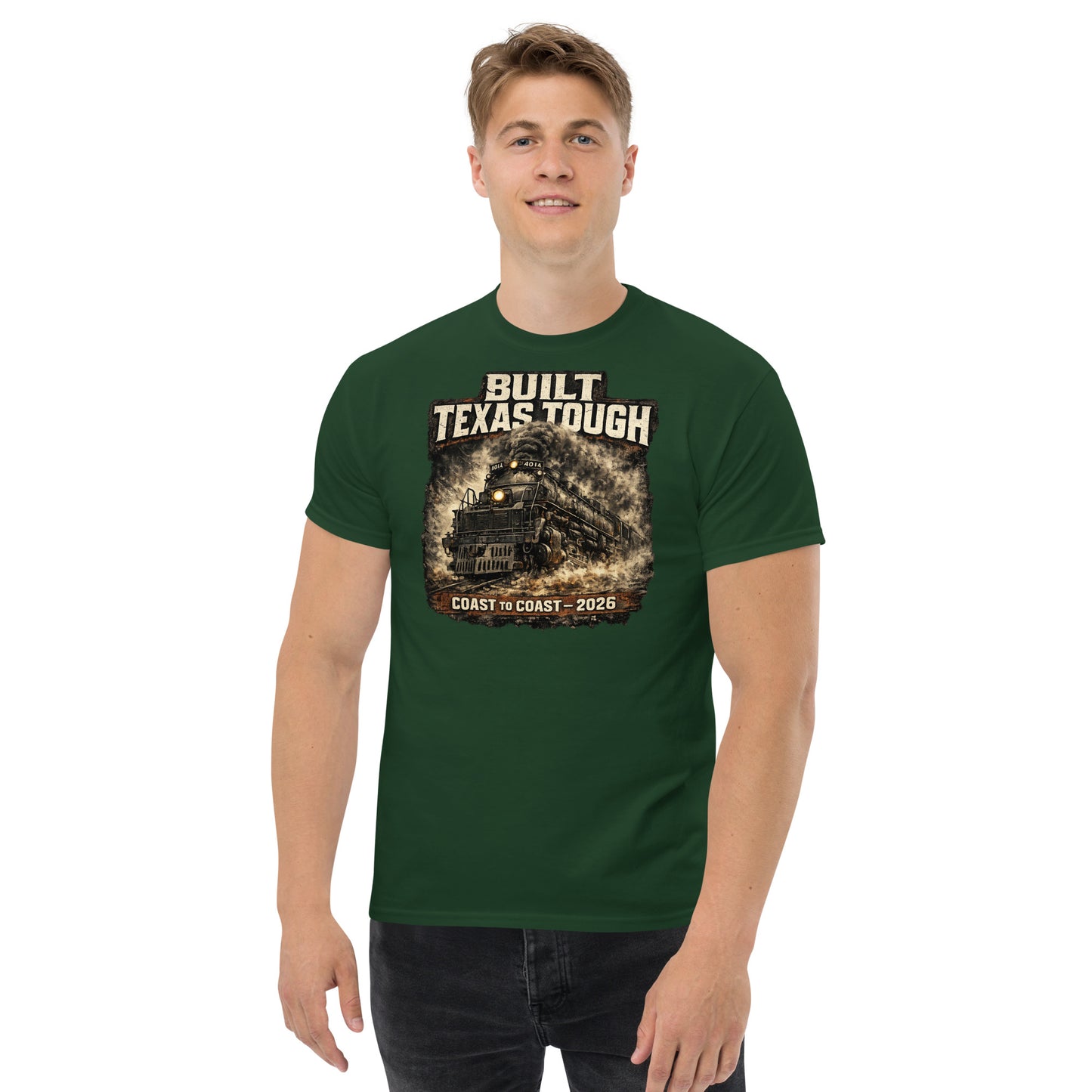Forest green t-shirt featuring a gritty, cinematic graphic of the Big Boy 4014 steam locomotive emerging from thick smoke with text reading "Built Texas Tough" and "Coast to Coast - 2026".