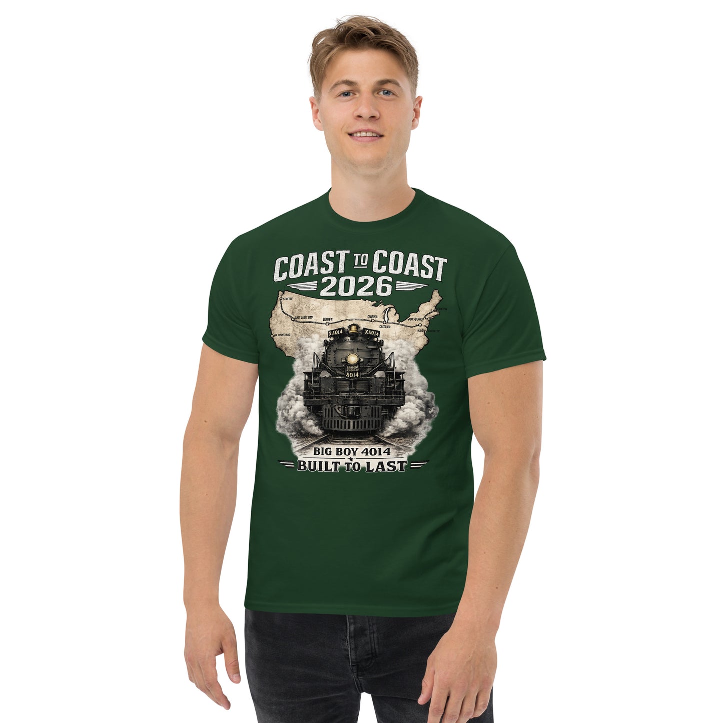 Forest green t-shirt featuring a head-on graphic of the Big Boy 4014 steam locomotive emerging from a vintage US map showing a cross-country route, with text reading "Coast to Coast 2026" and "Built To Last".