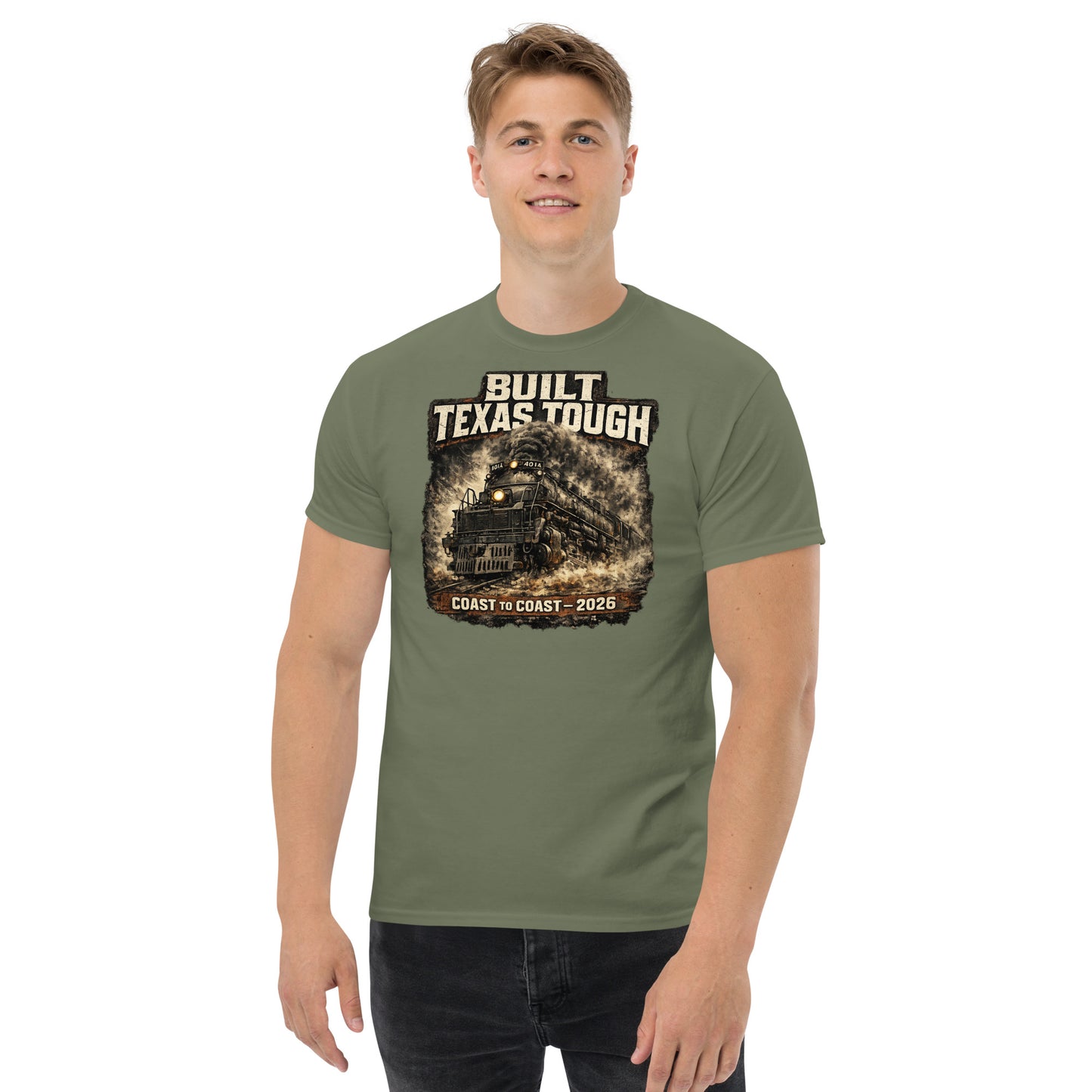 Army green t-shirt featuring a gritty, cinematic graphic of the Big Boy 4014 steam locomotive emerging from thick smoke with text reading "Built Texas Tough" and "Coast to Coast - 2026".