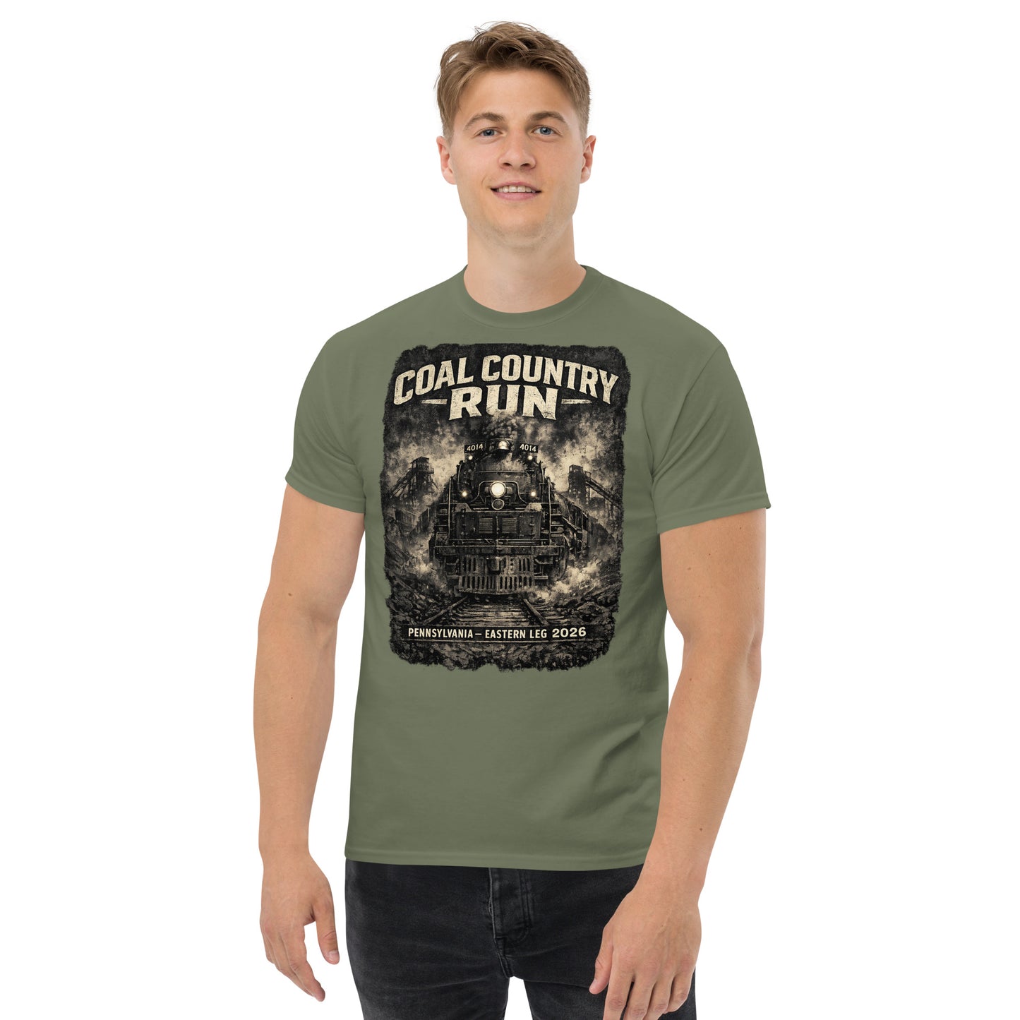 Army green t-shirt featuring a dark, gritty graphic of the Big Boy 4014 steam locomotive passing historic coal mine structures, with text reading "Coal Country Run" and "Pennsylvania - Eastern Leg 2026".