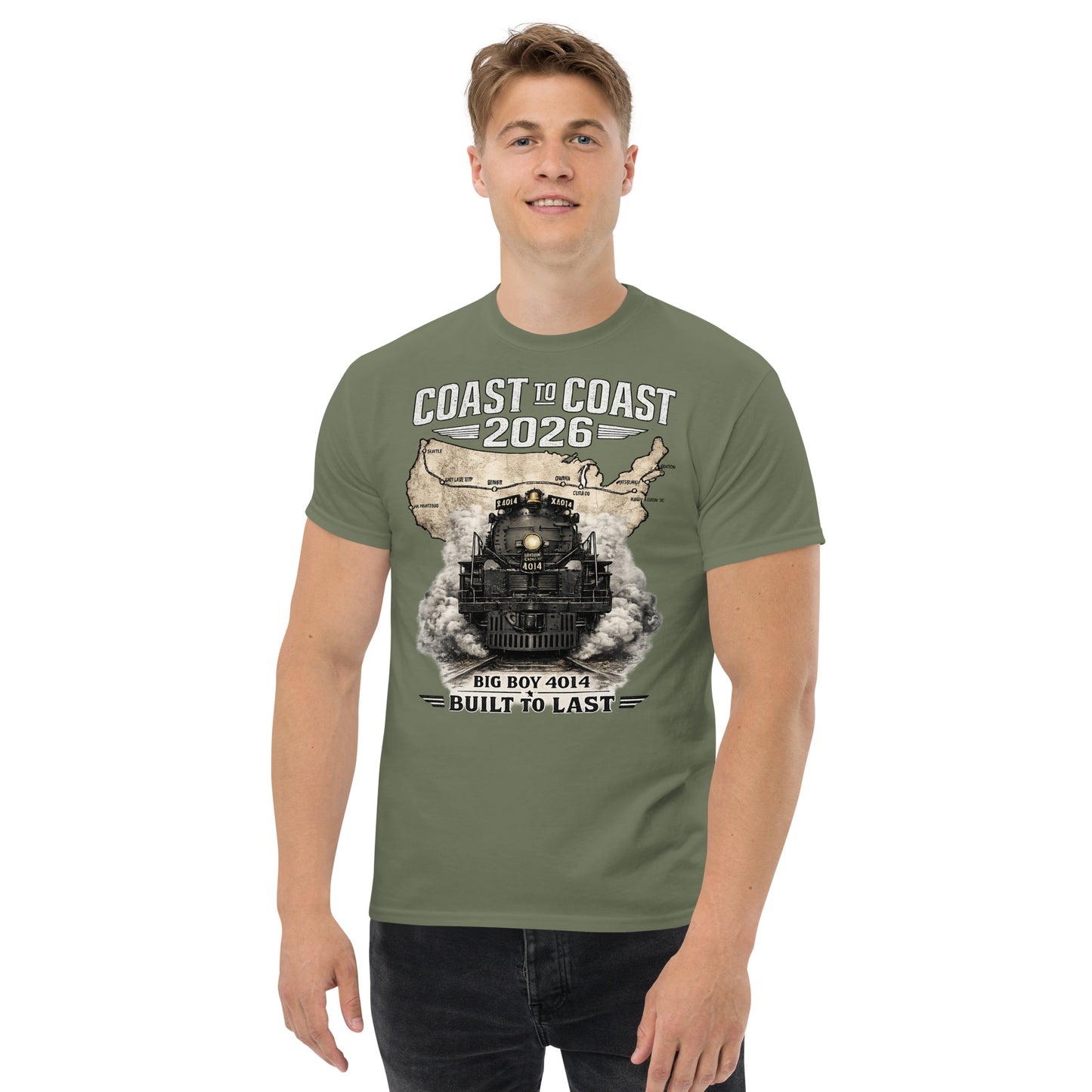 Army green t-shirt featuring a head-on graphic of the Big Boy 4014 steam locomotive emerging from a vintage US map showing a cross-country route, with text reading "Coast to Coast 2026" and "Built To Last".