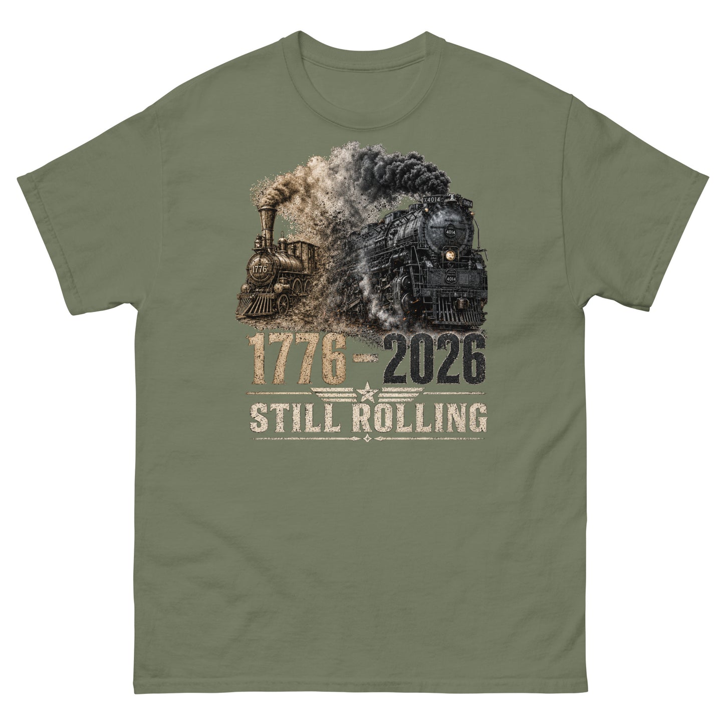 Army green t-shirt featuring a detailed graphic of two steam locomotives from different eras emerging from heavy smoke side-by-side, with bold distressed text reading "1776-2026" and "STILL ROLLING" flanked by a vintage star and wings emblem.