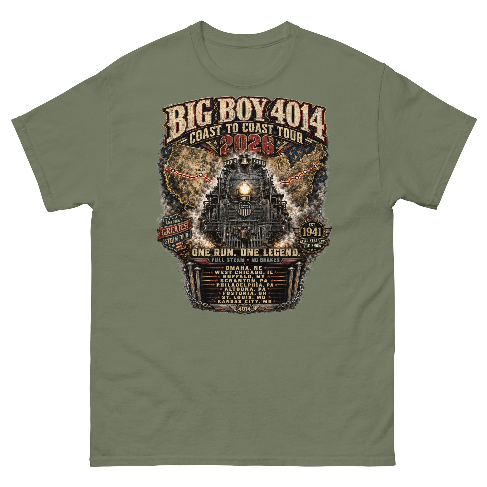 Army green t-shirt featuring a highly detailed, industrial graphic of the Big Boy 4014 steam locomotive backed by a US map, with text reading "BIG BOY 4014 COAST TO COAST TOUR 2026", "ONE RUN. ONE LEGEND.", and a roster of tour stops from Omaha to Kansas City surrounded by metal spikes and chains.