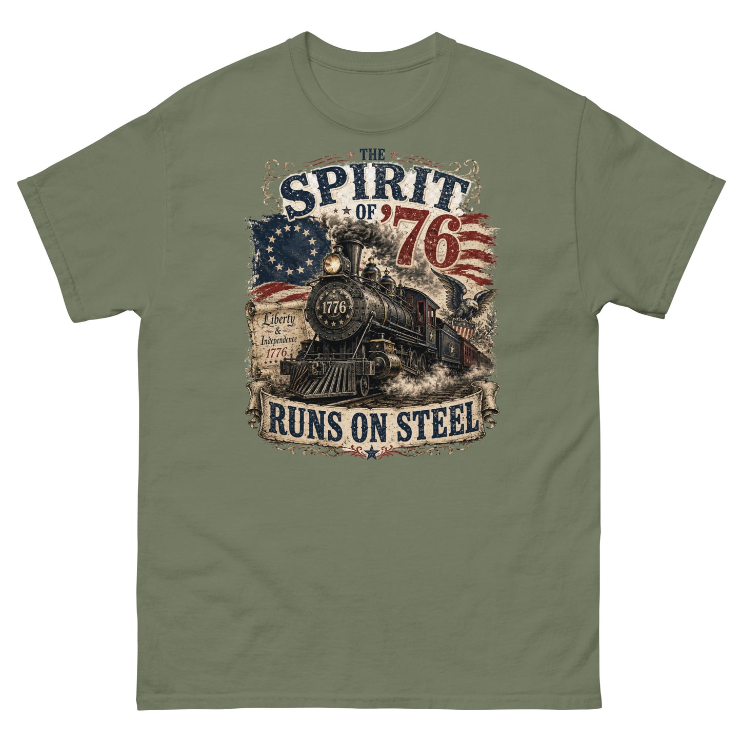 Army green t-shirt featuring a highly detailed vintage graphic. At the top, distressed text reads "THE SPIRIT OF '76". The center shows a classic steam locomotive with "1776" on the front plate, bursting from a 13-star Betsy Ross American flag. A bald eagle flies on the right, and a parchment scroll on the left reads "Liberty & Independence 1776". A banner at the bottom reads "RUNS ON STEEL".