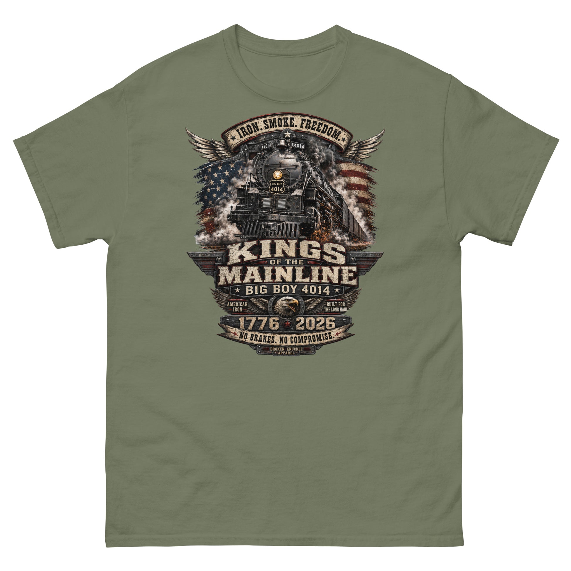 Army green t-shirt featuring a highly detailed patriotic graphic. The Big Boy 4014 steam locomotive is centered against a distressed American flag and wings. A banner at the top reads "IRON. SMOKE. FREEDOM." Large text reads "KINGS OF THE MAINLINE" and "BIG BOY 4014". Below is a bald eagle head between badges reading "AMERICAN IRON" and "BUILT FOR THE LONG HAUL". The bottom features "1776 - 2026", "NO BRAKES. NO COMPROMISE.", and "BROKEN KNUCKLE APPAREL".