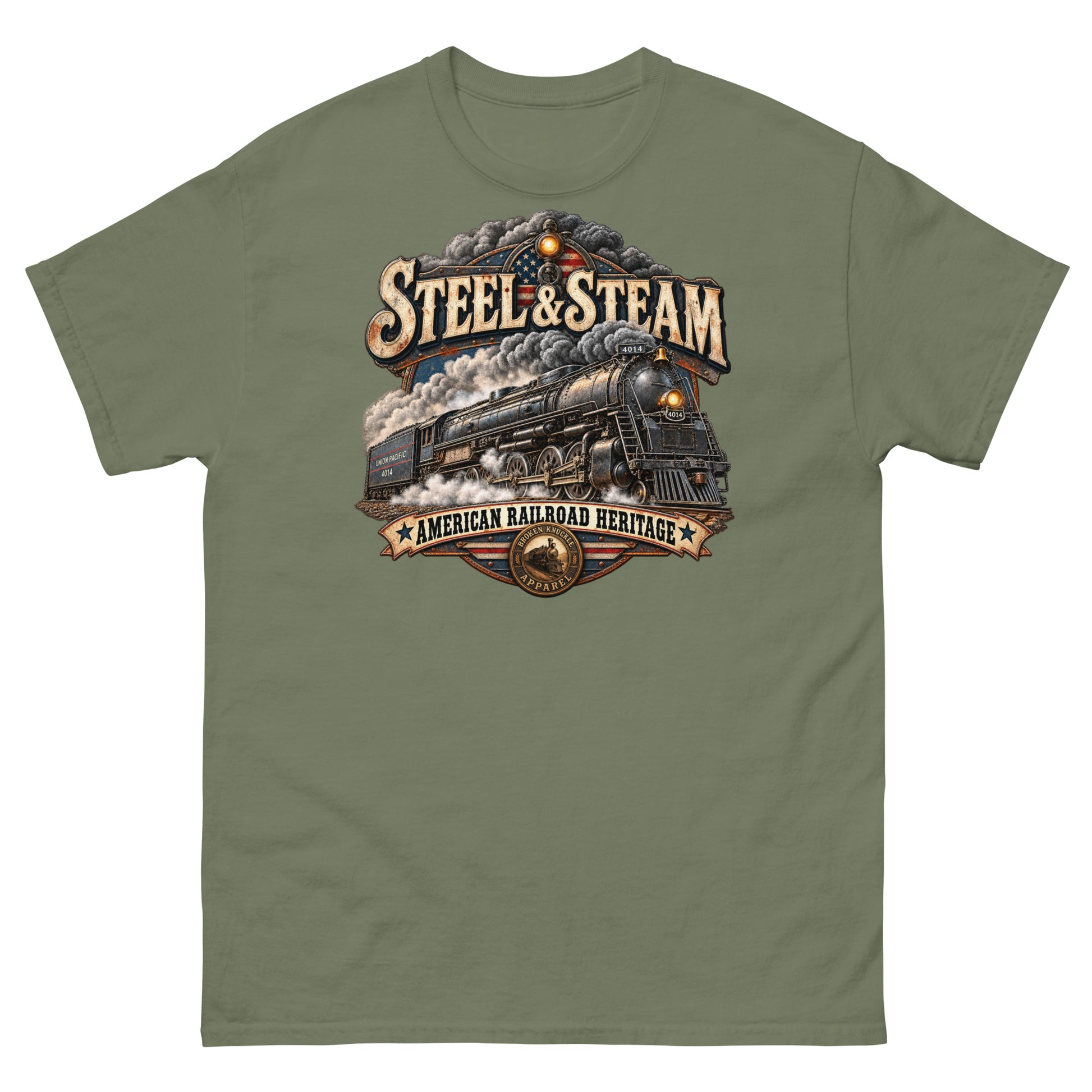 Army green classic t-shirt featuring a highly detailed vintage graphic. A steam locomotive charges forward surrounded by smoke, with an American flag motif in the background. Vintage distressed text reads "STEEL & STEAM" at the top and "AMERICAN RAILROAD HERITAGE" on a banner at the bottom, just above a round Broken Knuckle Apparel badge.