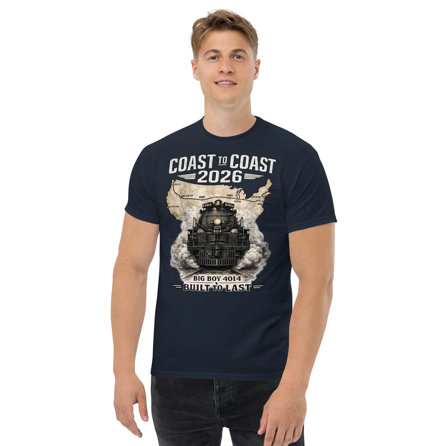 Navy t-shirt featuring a head-on graphic of the Big Boy 4014 steam locomotive emerging from a vintage US map showing a cross-country route, with text reading "Coast to Coast 2026" and "Built To Last".