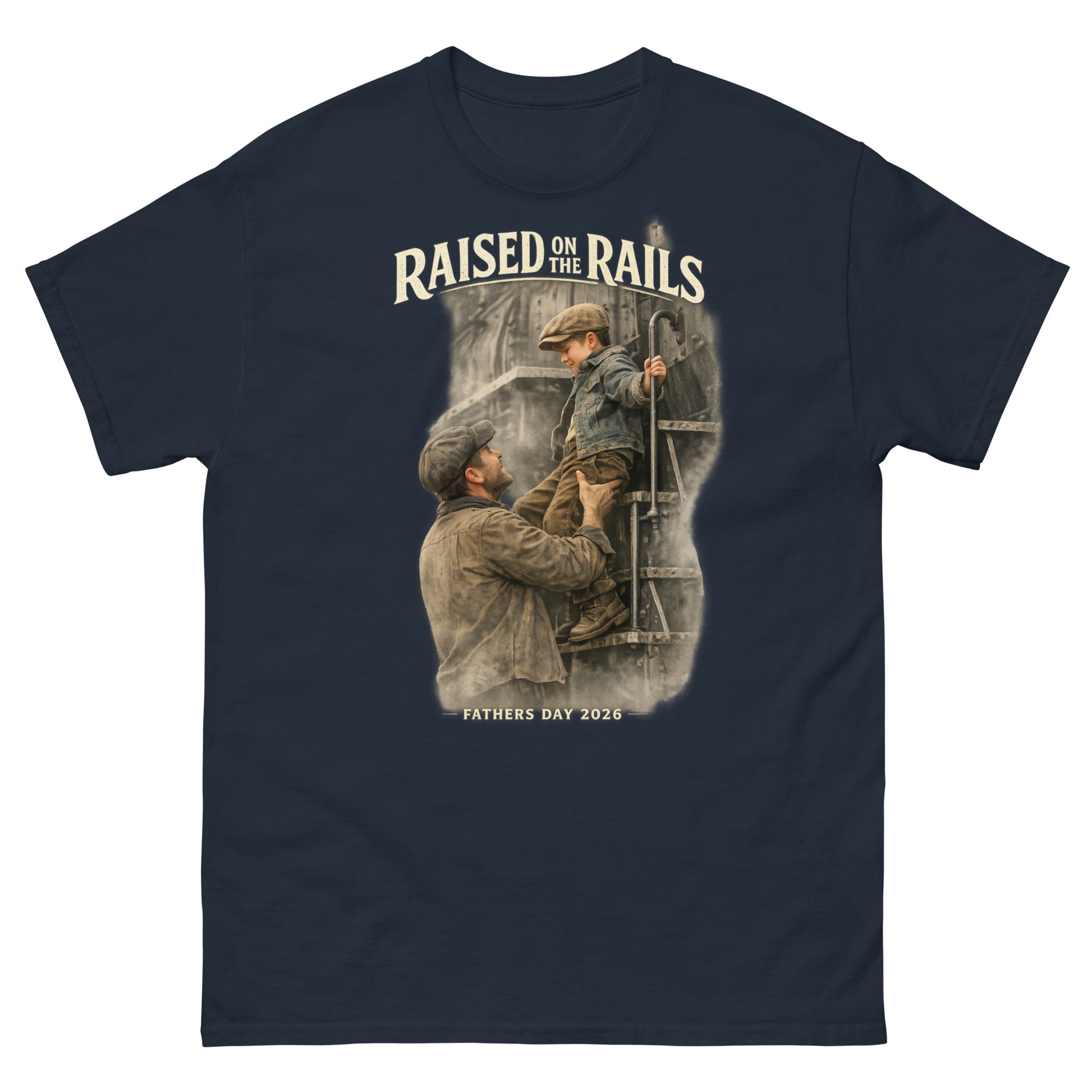 Navy t-shirt featuring a vintage-style graphic of a father lifting his young son onto a steam locomotive ladder, with text reading "Raised On The Rails" and "Fathers Day 2026".