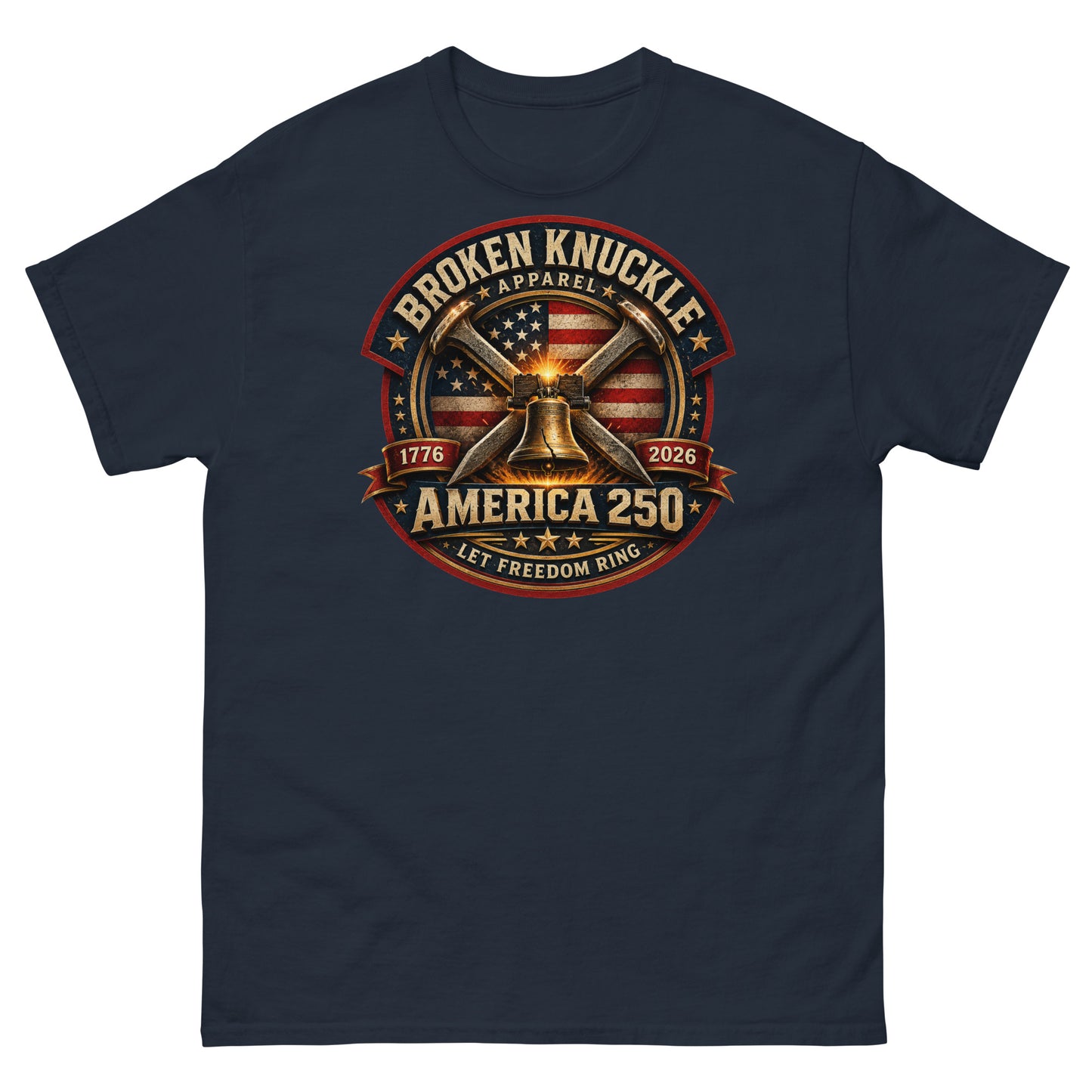 Navy t-shirt featuring a circular patriotic graphic. The design includes an American flag background, two crossed railroad spikes, and a glowing Liberty Bell in the center. Text around the badge reads "BROKEN KNUCKLE APPAREL", "1776", "2026", "AMERICA 250", and "LET FREEDOM RING".