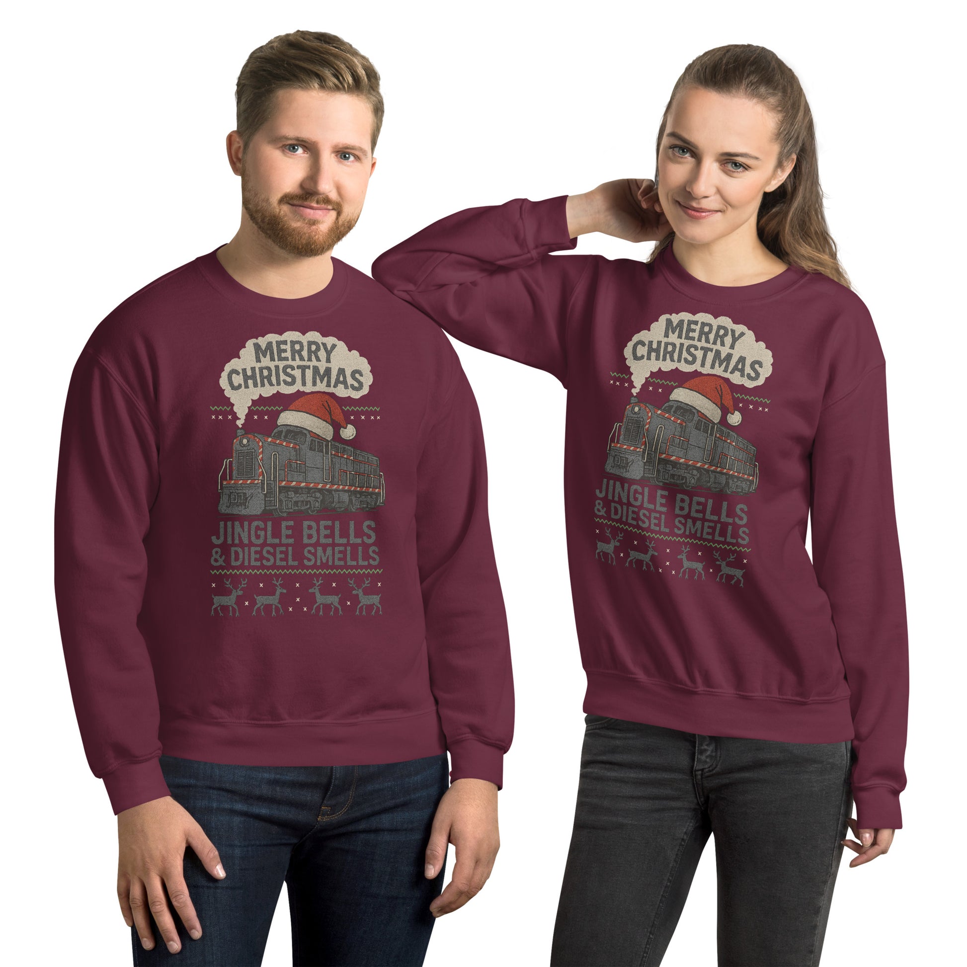 Two people wearing matching maroon Christmas-themed sweatshirts with a train design.