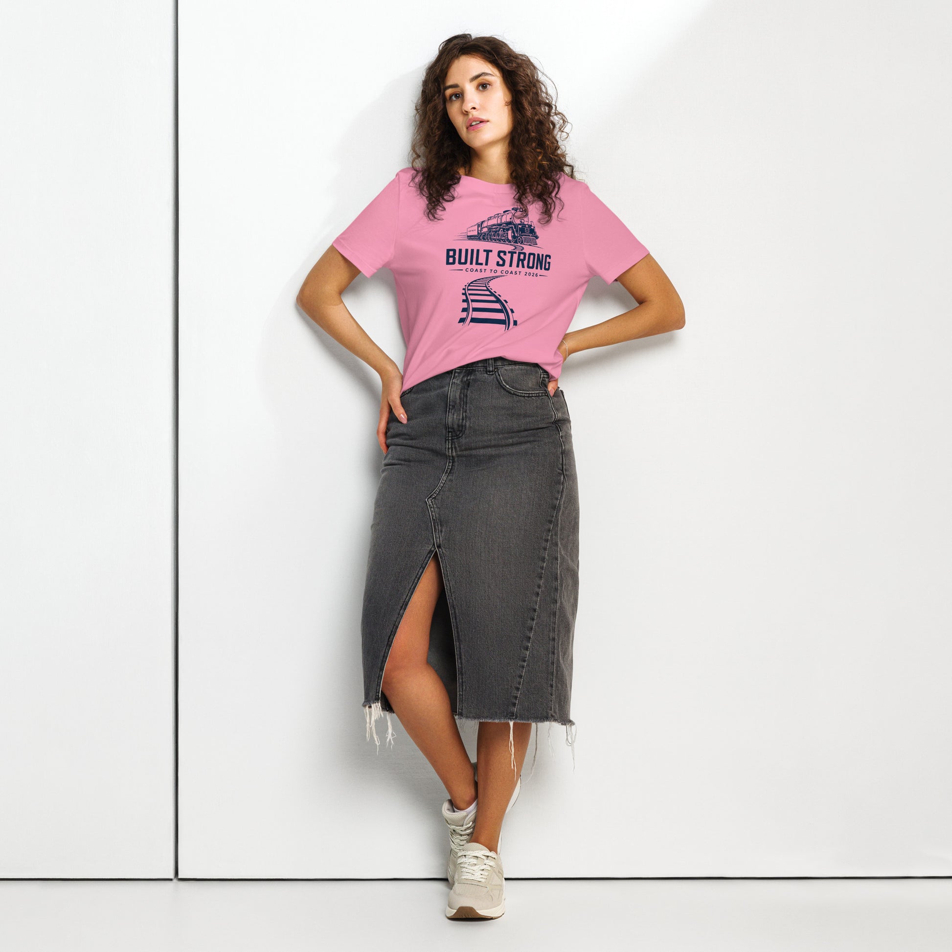 Pink women's t-shirt featuring a sleek, dark line-art graphic of the Big Boy 4014 steam locomotive on curving tracks, with text reading "Built Strong" and "Coast to Coast 2026".