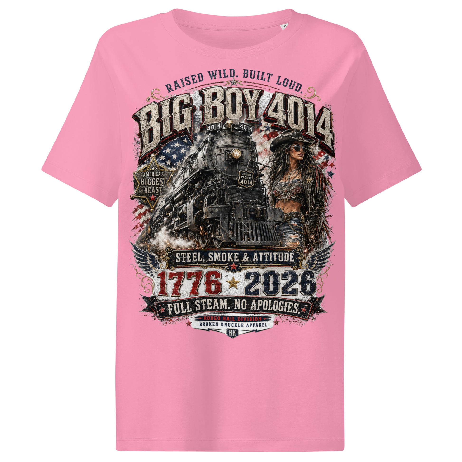 Pink women's ribbed neck t-shirt featuring a gritty graphic of the Big Boy 4014 steam locomotive next to a woman in a cowboy hat and leather jacket. The background includes a distressed American flag and eagle wings. Text reads "RAISED WILD. BUILT LOUD.", "BIG BOY 4014", "AMERICA'S BIGGEST BEAST", "STEEL, SMOKE & ATTITUDE", "1776 - 2026", "FULL STEAM. NO APOLOGIES.", and "RODEO RAIL DIVISION".