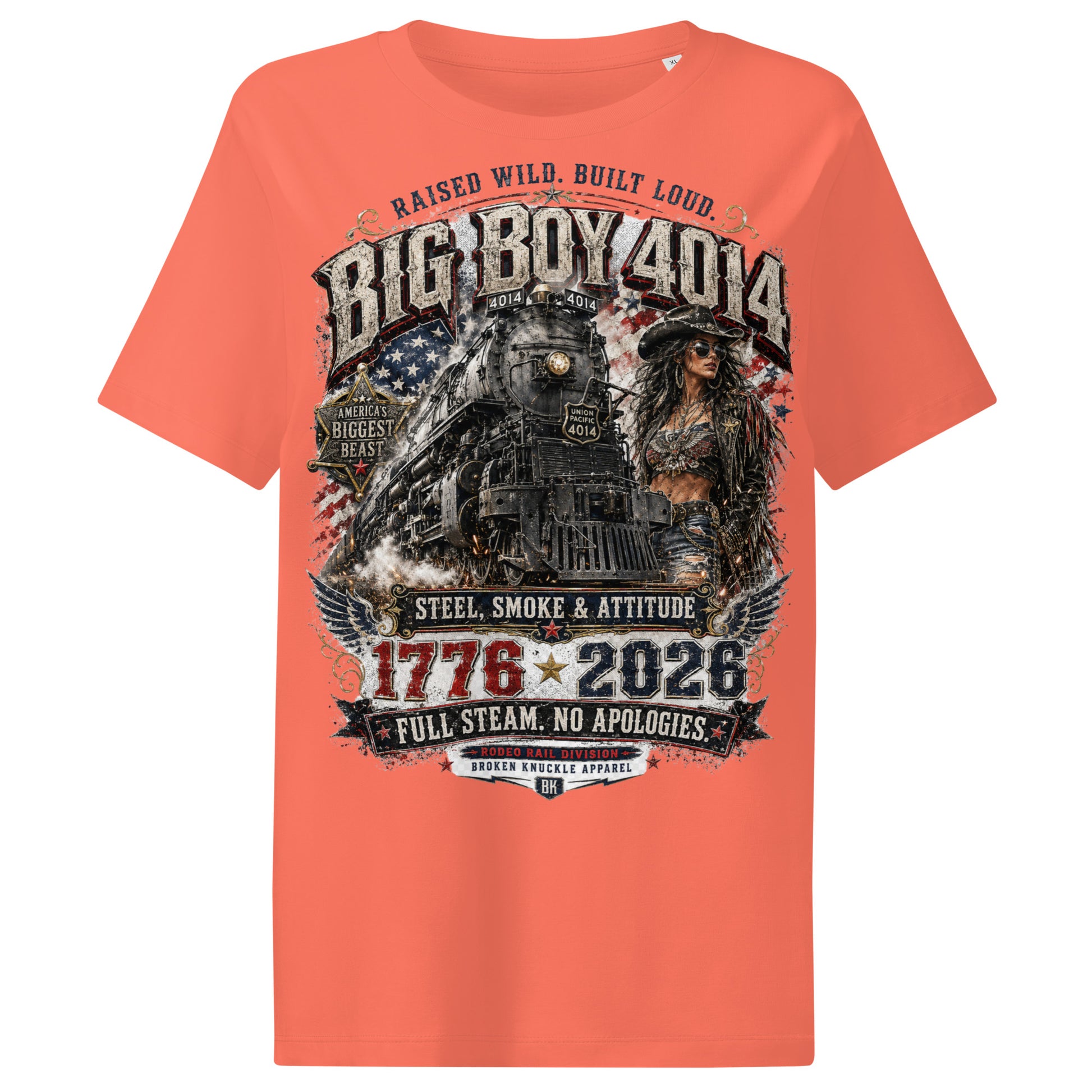 Orange women's ribbed neck t-shirt featuring a gritty graphic of the Big Boy 4014 steam locomotive next to a woman in a cowboy hat and leather jacket. The background includes a distressed American flag and eagle wings. Text reads "RAISED WILD. BUILT LOUD.", "BIG BOY 4014", "AMERICA'S BIGGEST BEAST", "STEEL, SMOKE & ATTITUDE", "1776 - 2026", "FULL STEAM. NO APOLOGIES.", and "RODEO RAIL DIVISION".