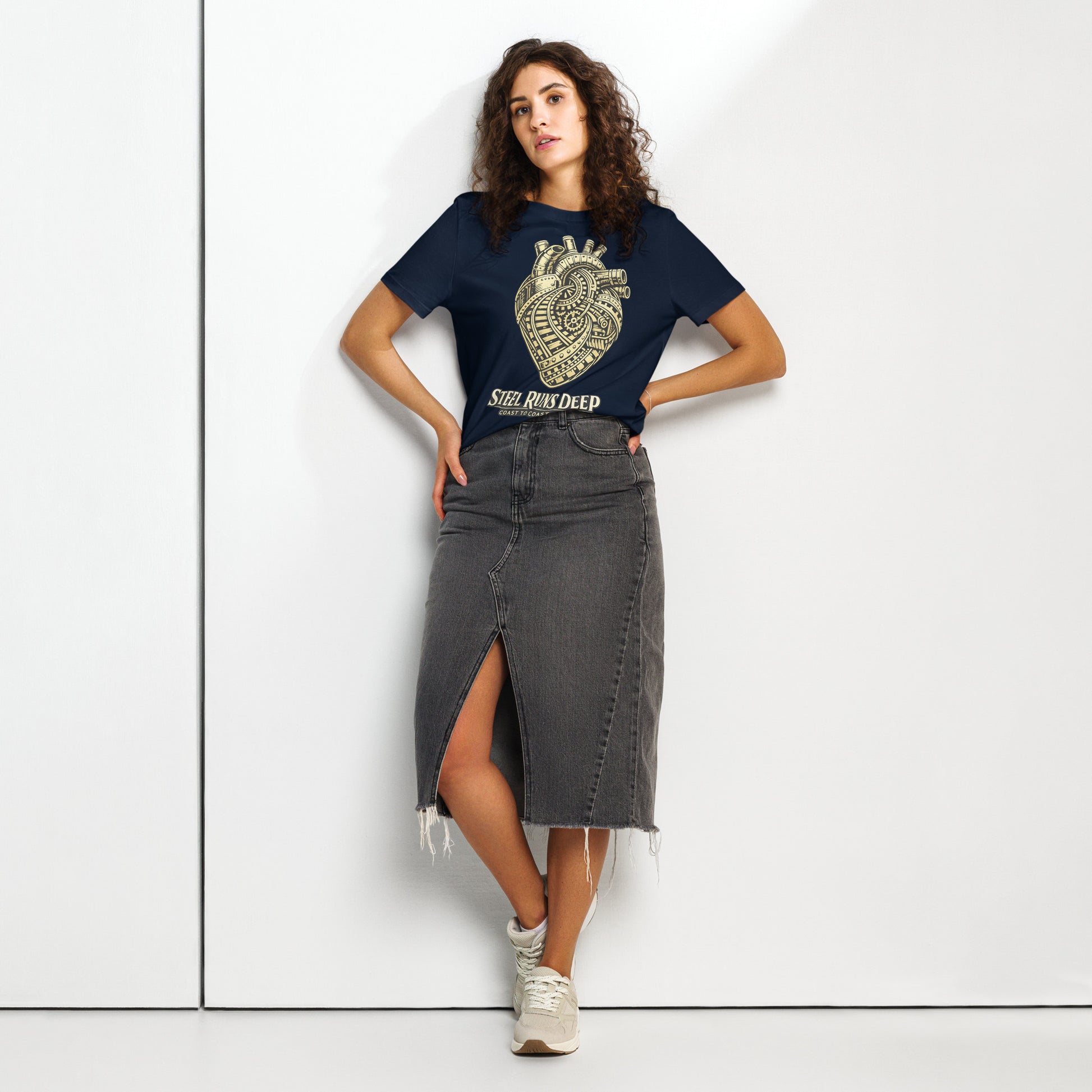 Navy women's t-shirt featuring an intricate vintage illustration of a mechanical heart made of train tracks and gears, with text reading "Steel Runs Deep" and "Coast to Coast 2026".