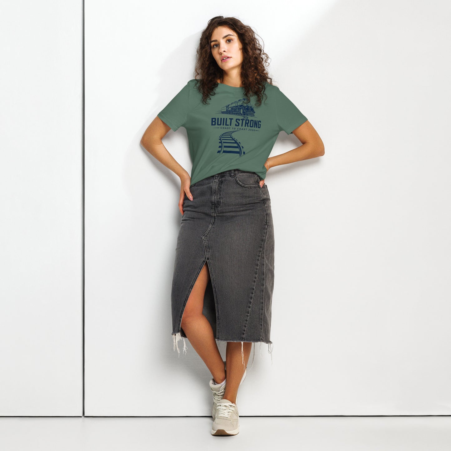green women's t-shirt featuring a sleek, dark line-art graphic of the Big Boy 4014 steam locomotive on curving tracks, with text reading "Built Strong" and "Coast to Coast 2026".