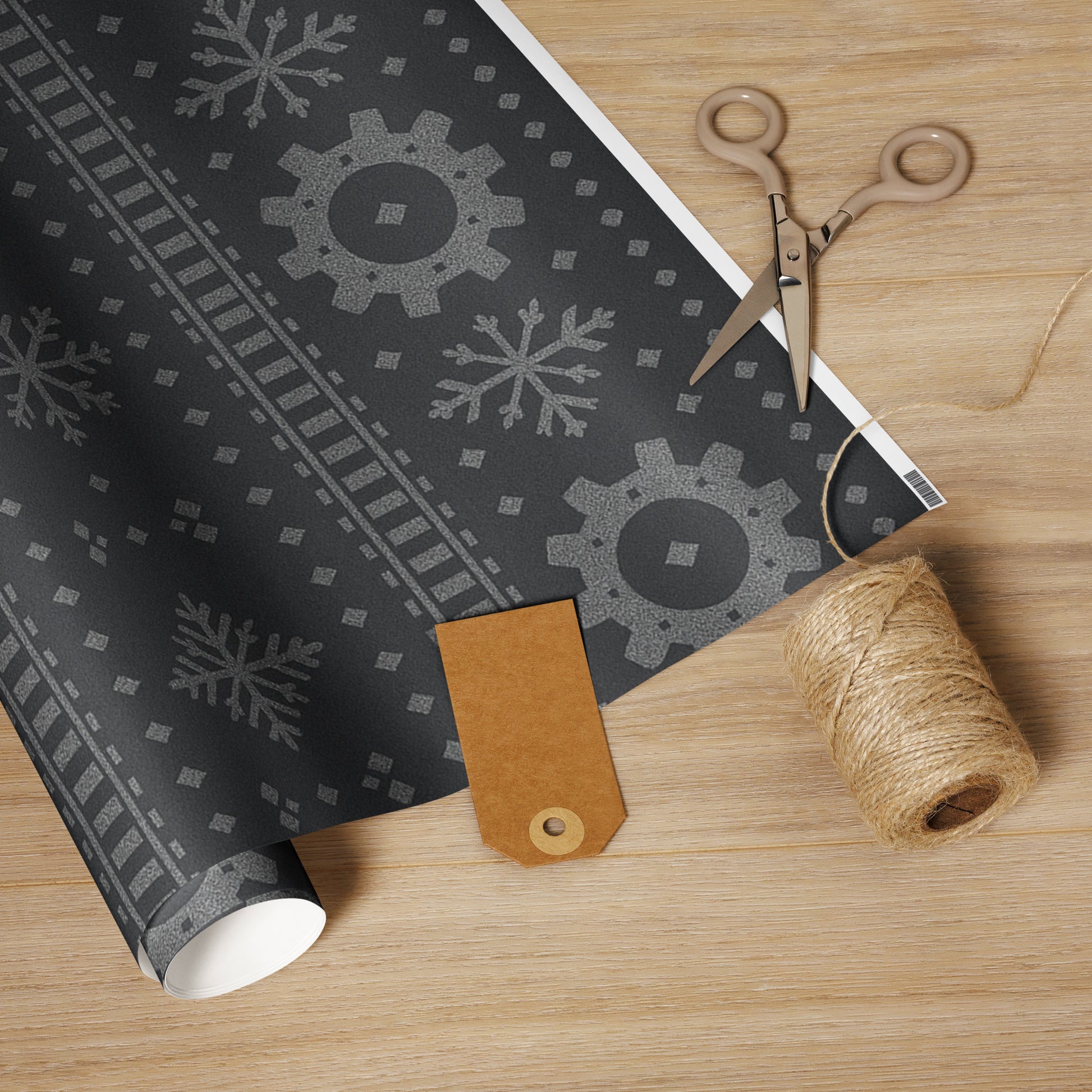 Roll of black patterned paper with a brown leather tag and scissors on a wooden surface