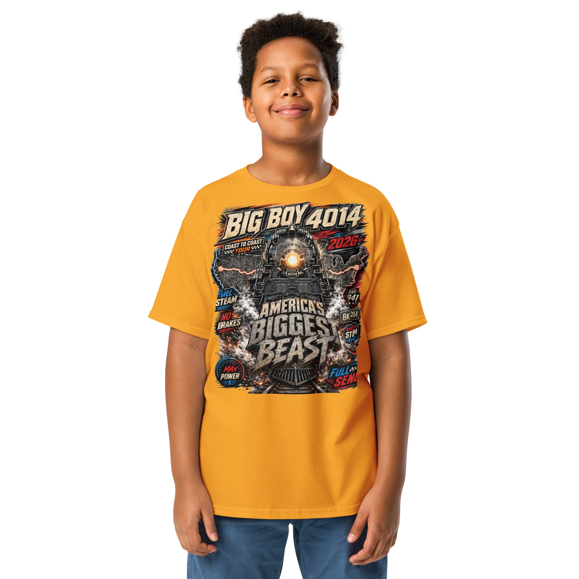Child wearing a yellow t-shirt featuring a high-energy, colorful graphic of the Big Boy 4014 steam locomotive backed by a US map, with bold text reading "BIG BOY 4014", "COAST TO COAST TOUR 2026", "AMERICA'S BIGGEST BEAST", "FULL STEAM", "NO BRAKES", "MAX POWER", and "FULL SEND".