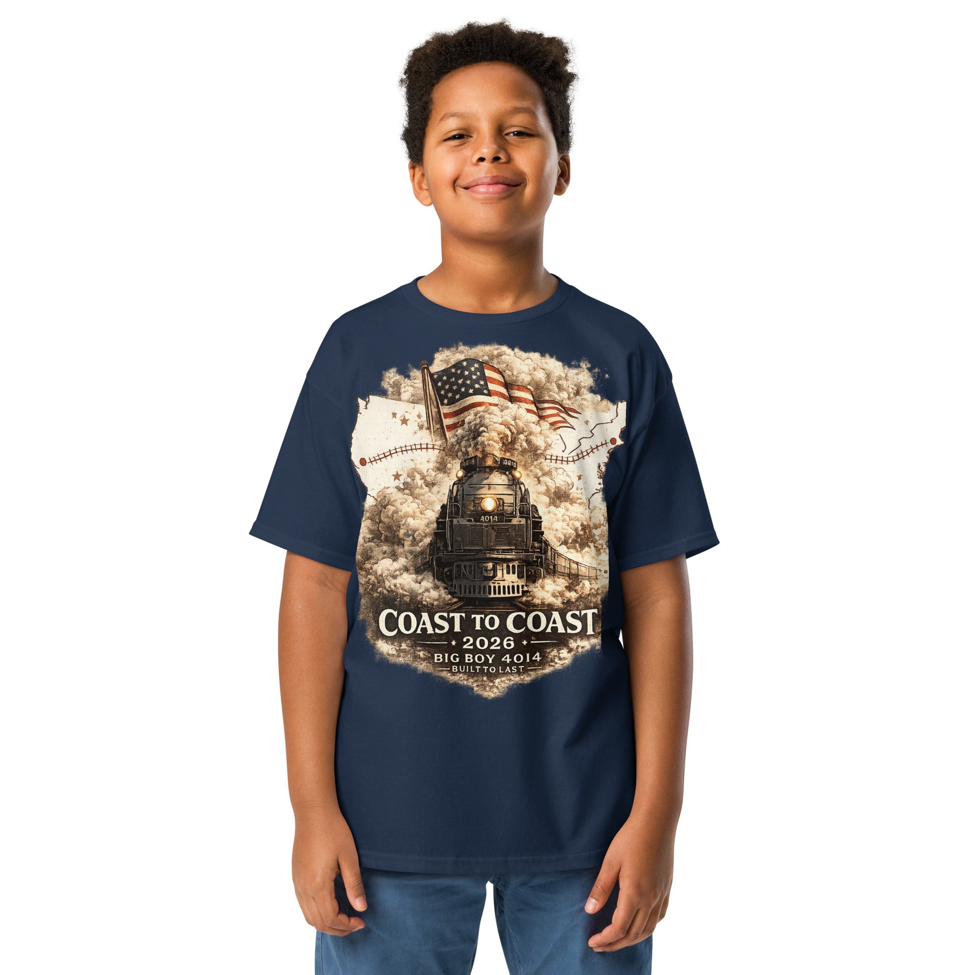 Child wearing a navy t-shirt featuring the Big Boy 4014 steam locomotive, a waving American flag, and a US map showing a track route, with text reading "Coast to Coast 2026", "Big Boy 4014", and "Built To Last".