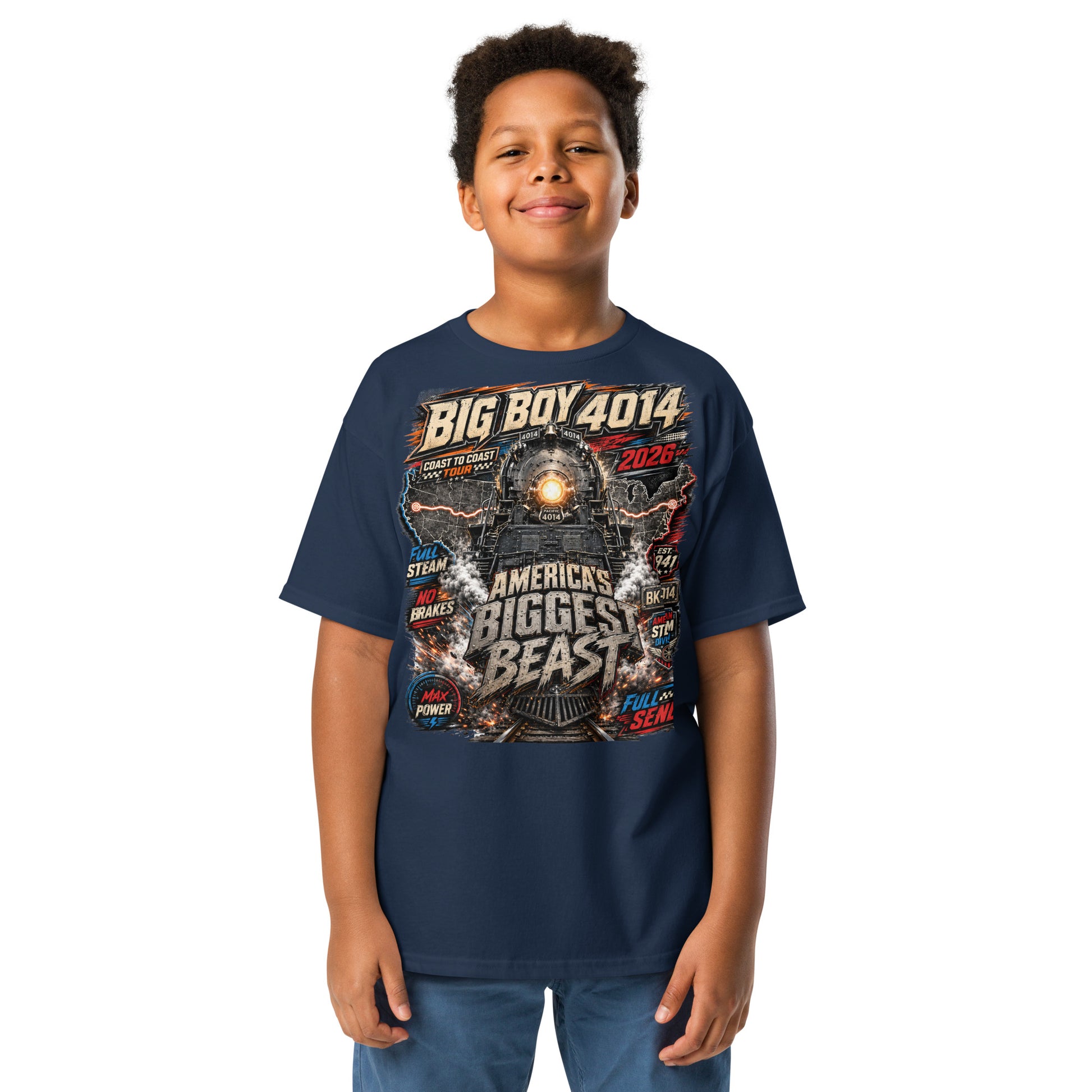 Child wearing a navy blue t-shirt featuring a high-energy, colorful graphic of the Big Boy 4014 steam locomotive backed by a US map, with bold text reading "BIG BOY 4014", "COAST TO COAST TOUR 2026", "AMERICA'S BIGGEST BEAST", "FULL STEAM", "NO BRAKES", "MAX POWER", and "FULL SEND".