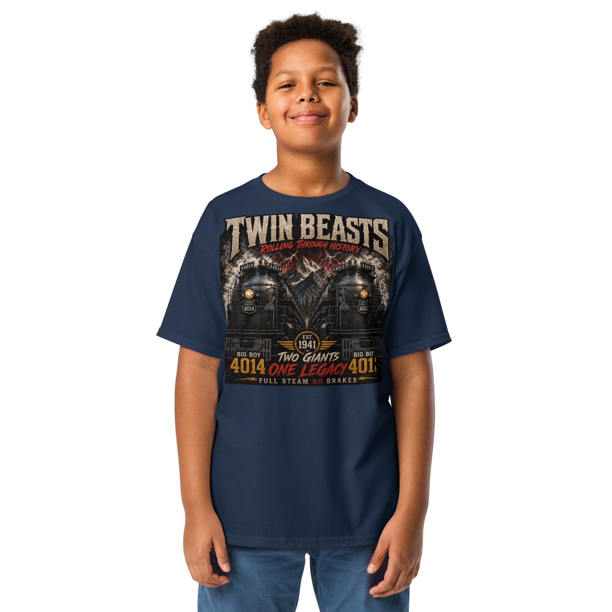 Youth navy t-shirt featuring a symmetrical graphic of two steam locomotives, Big Boy 4014 on the left and Big Boy 4012 on the right, side-by-side in front of a mountain range with red lightning strikes. Text reads "TWIN BEASTS", "ROLLING THROUGH HISTORY", "EST. 1941", "TWO GIANTS ONE LEGACY", and "FULL STEAM NO BRAKES".
