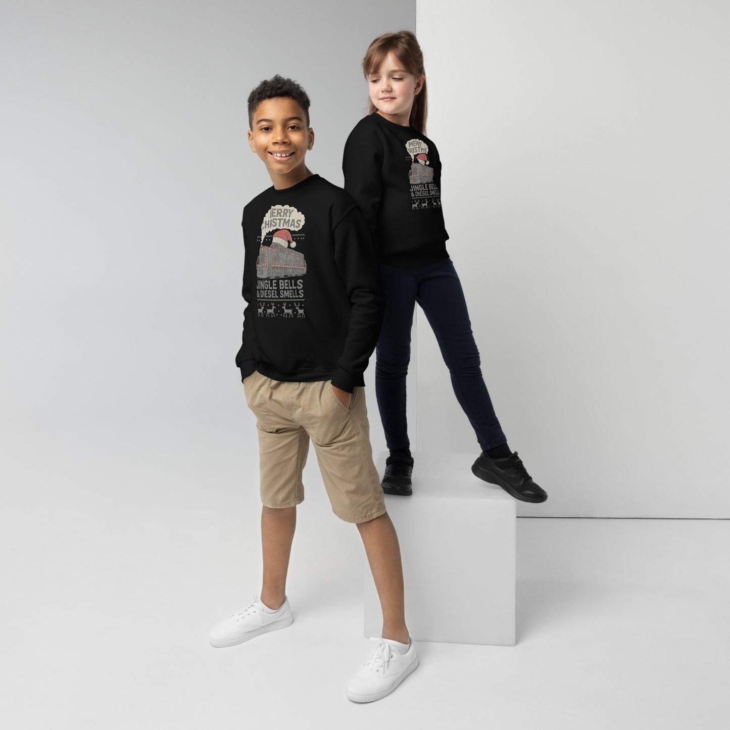 Two children wearing black sweatshirts with graphic designs on a white background