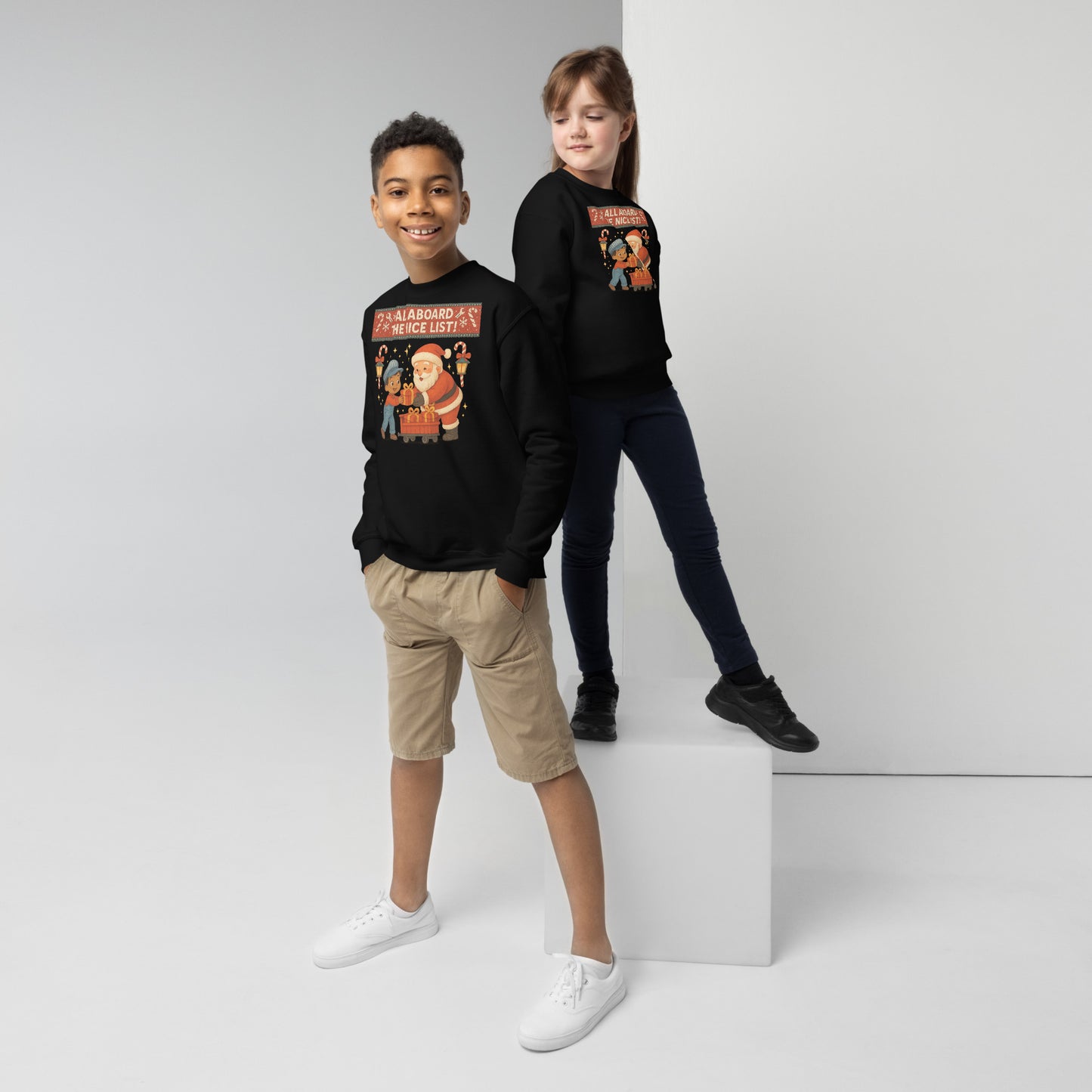 Two children wearing black sweatshirts with colorful graphics on a white background