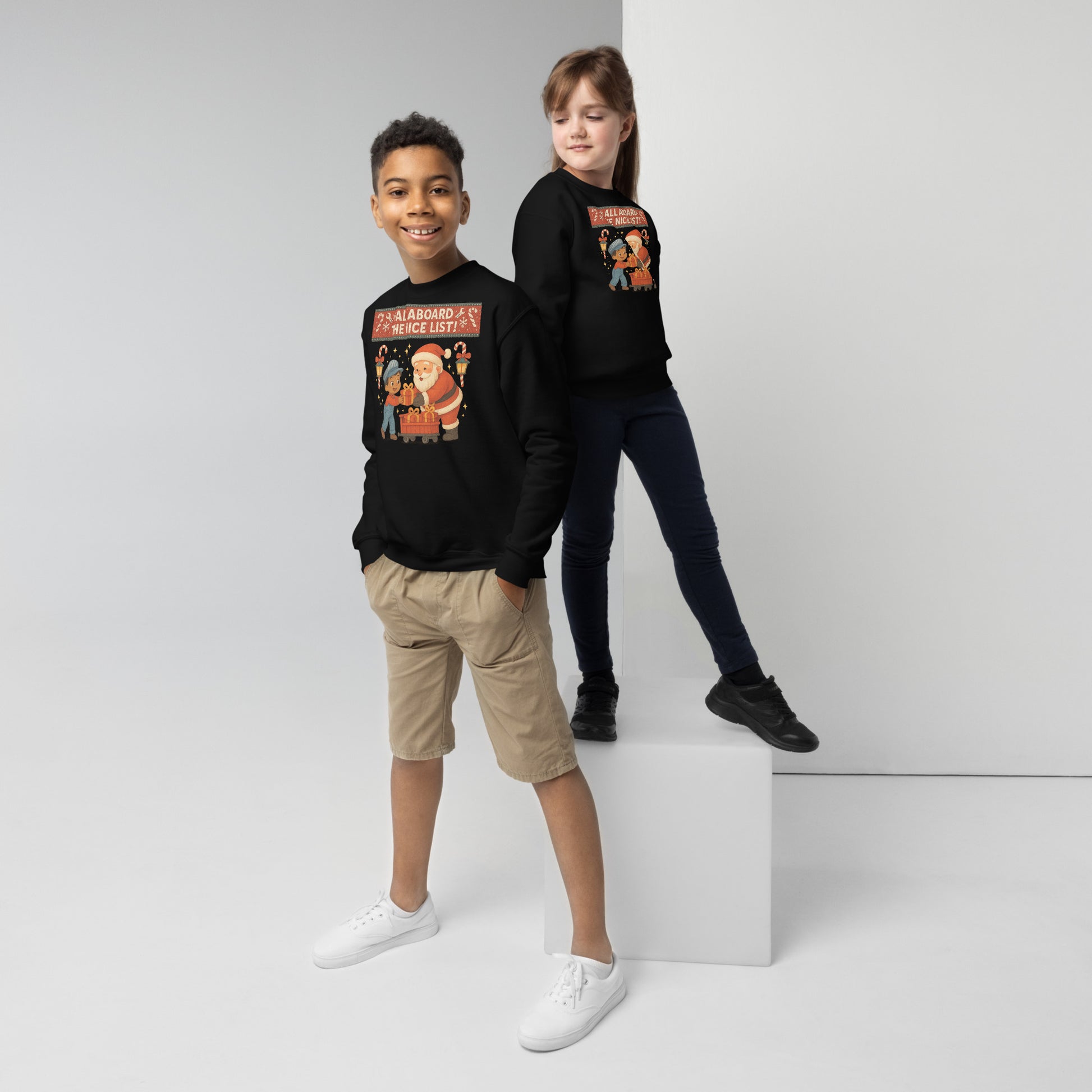 Two children wearing black sweatshirts with colorful graphics on a white background