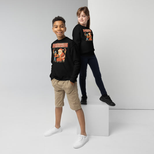 Two children wearing black sweatshirts with colorful graphics on a white background