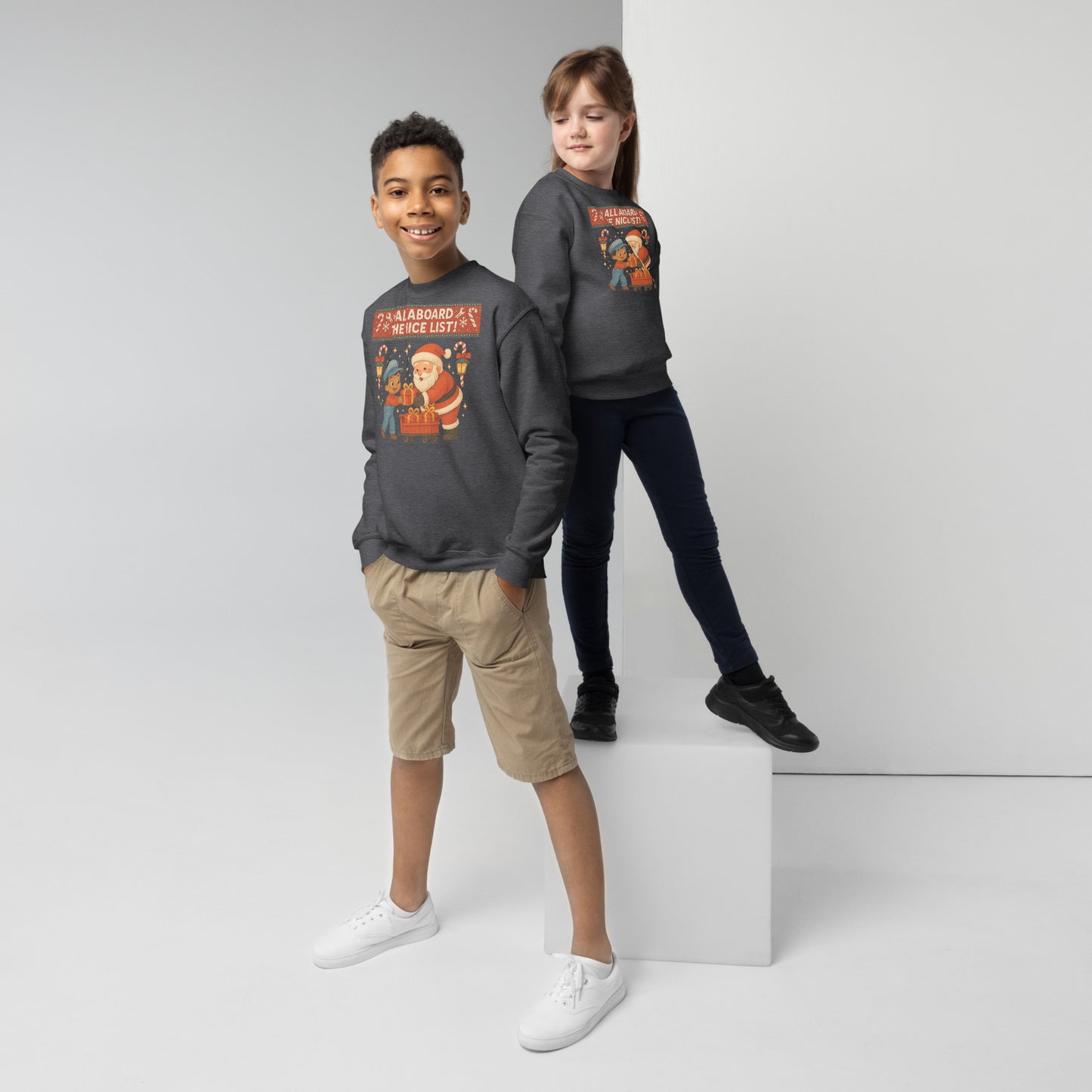 Two children wearing matching dark gray sweatshirts with a graphic design on a white background