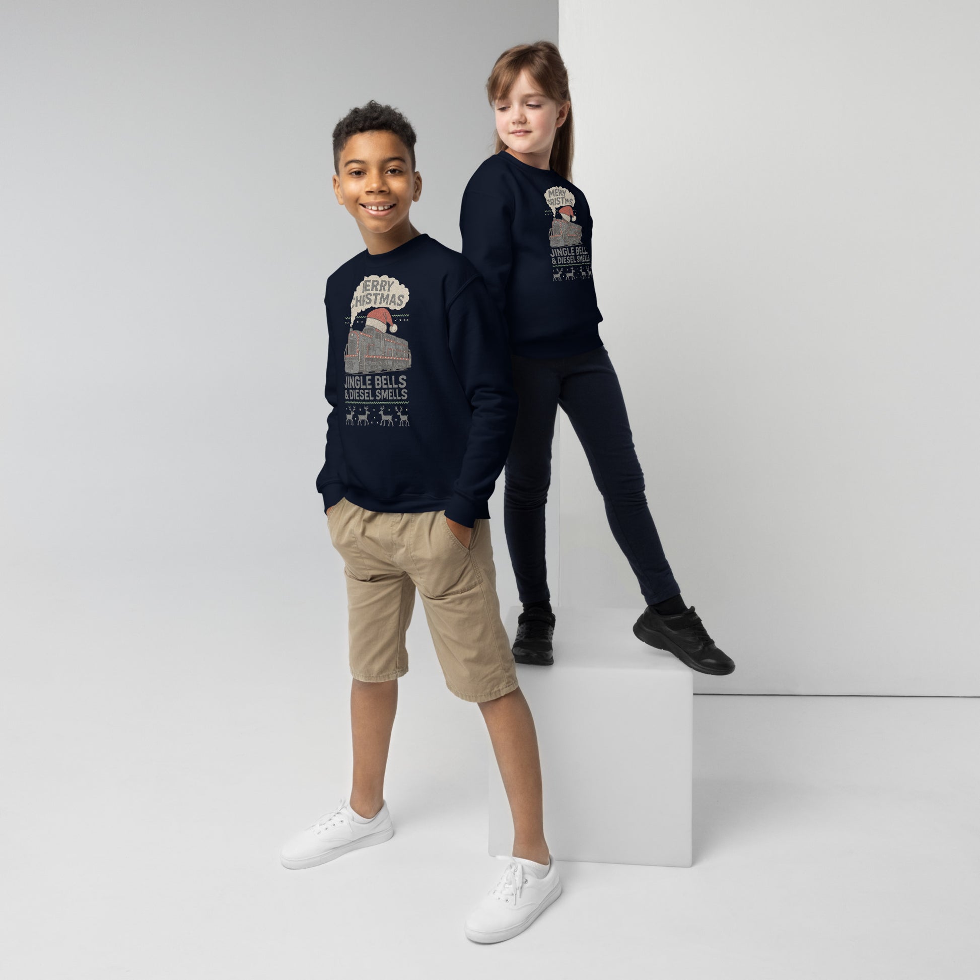 Two children wearing navy blue sweatshirts with graphic designs on a white background