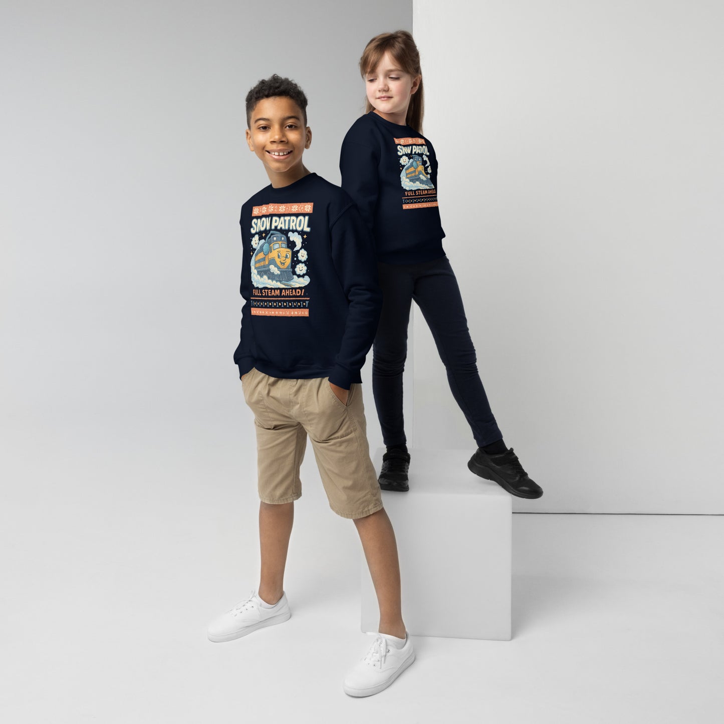 Two children wearing navy sweatshirts with a graphic design on a white background
