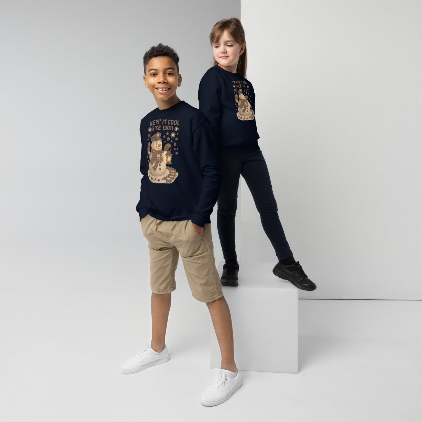 Two children wearing navy blue sweatshirts with graphic designs on a white background