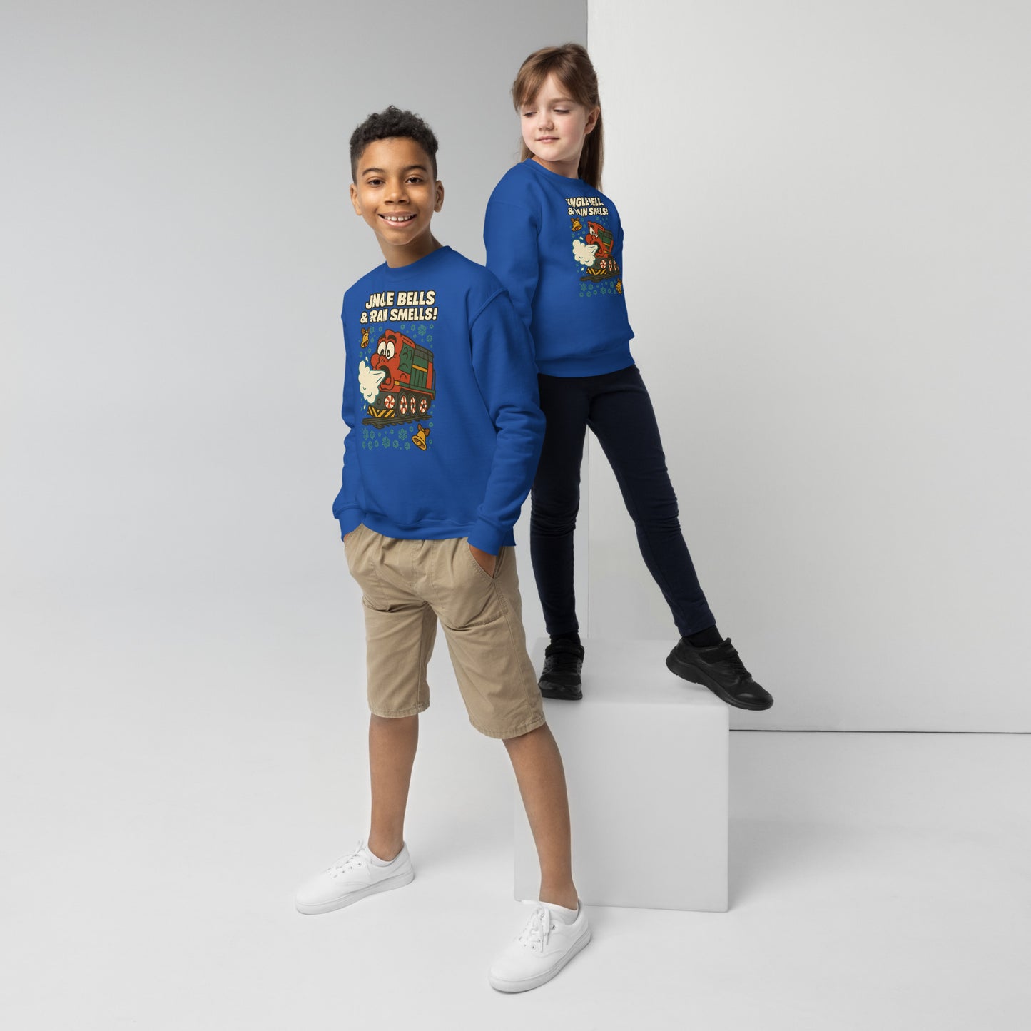 Two children wearing blue sweatshirts with cartoon characters on a white background
