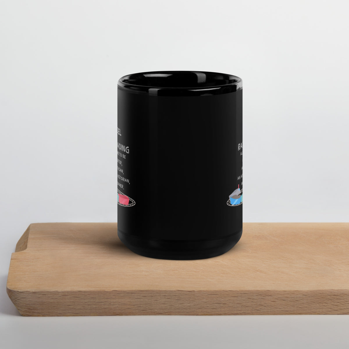 Glossy black Model Railroading mug shown from the side on a wooden board